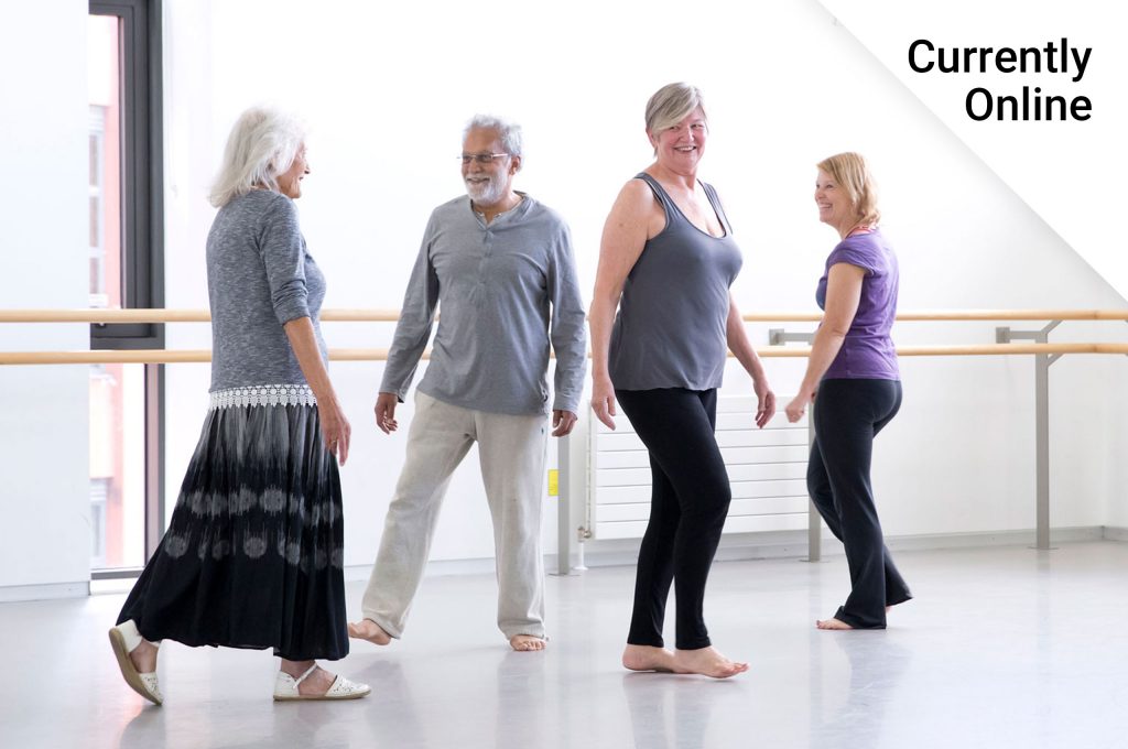 A man and three women wearing casual clothes standing in a dance studio smiling with the words 'Currently online'..