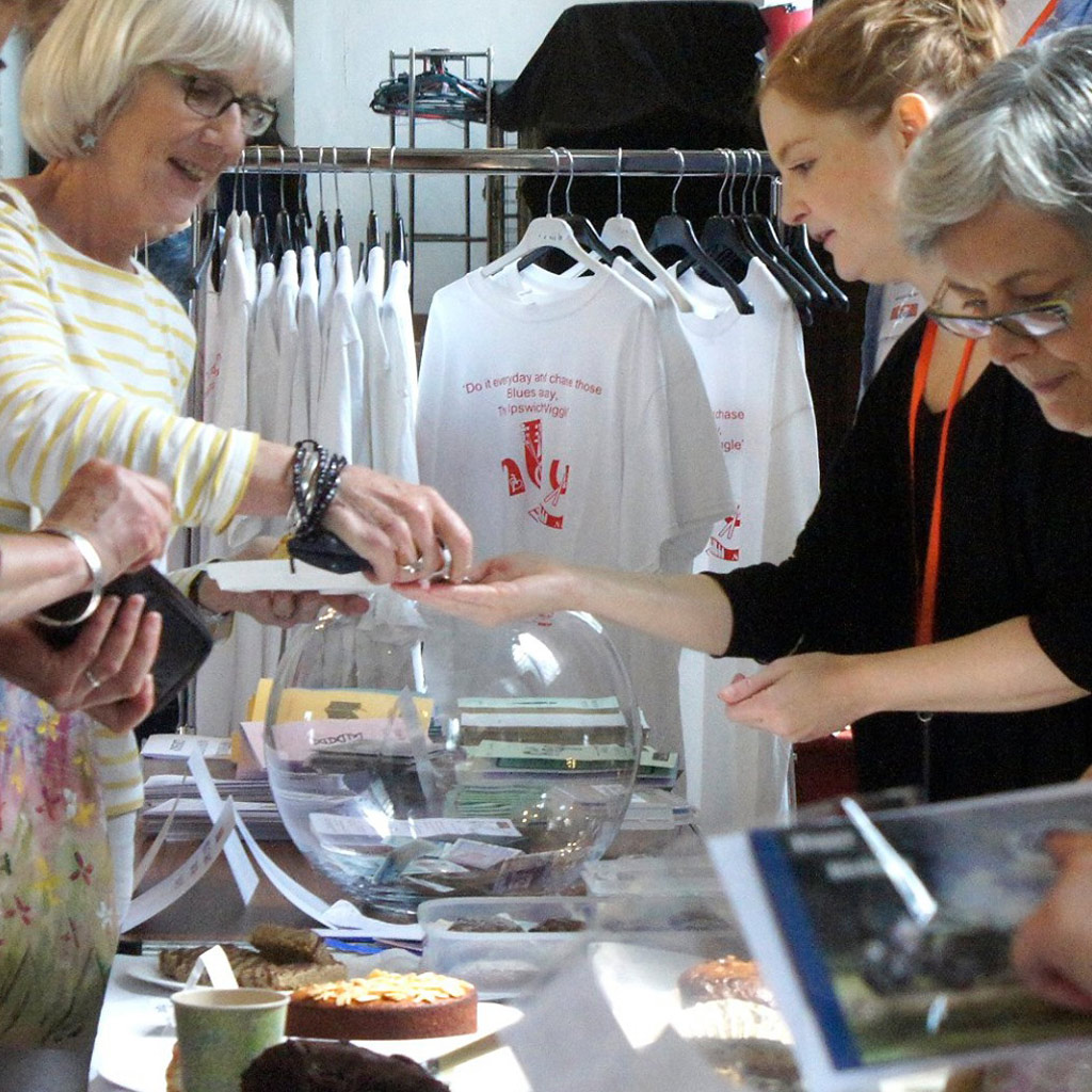 A woman making a purchase at a fundraising event.