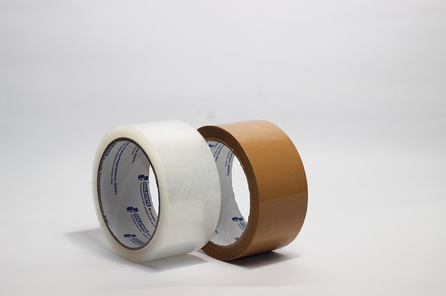 Two reels of tape, one brown, one white.